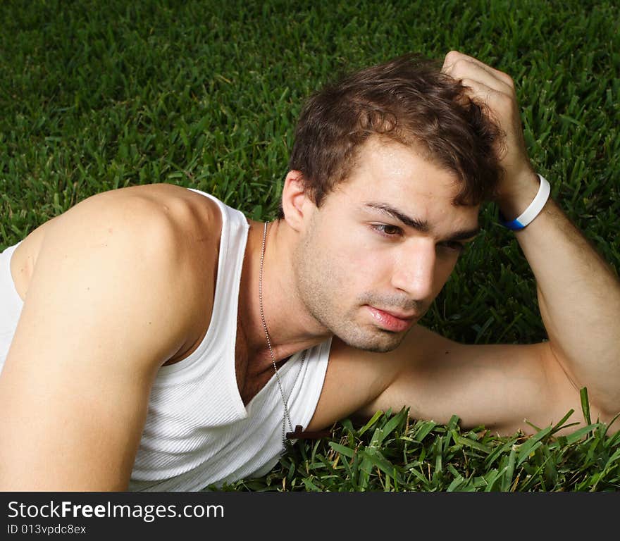 Young Man Laying On The Grass