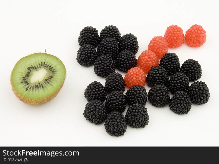 Candy and kiwi on white background