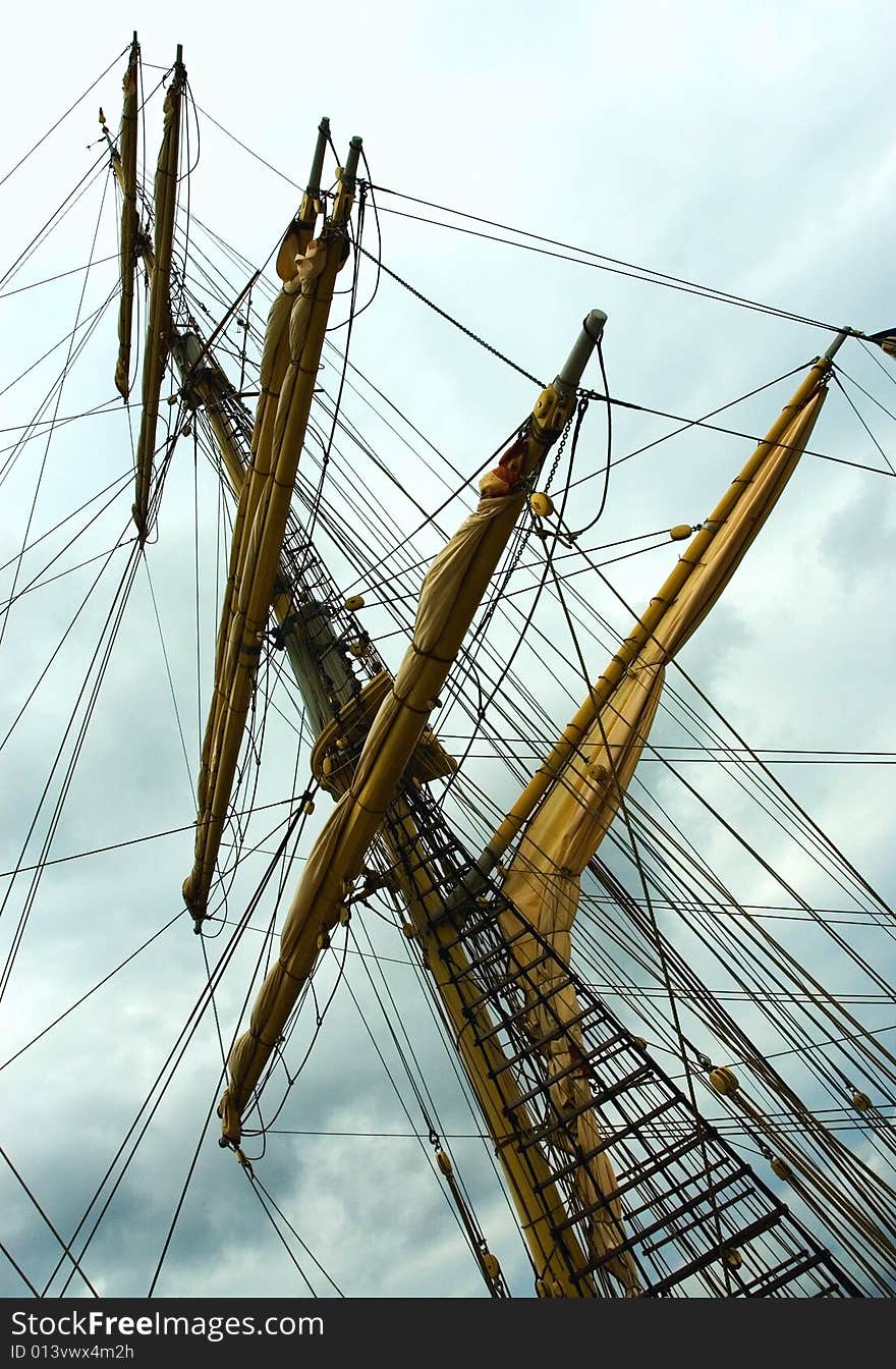 Mast of old sailing yacht at sunset over the sky. Mast of old sailing yacht at sunset over the sky