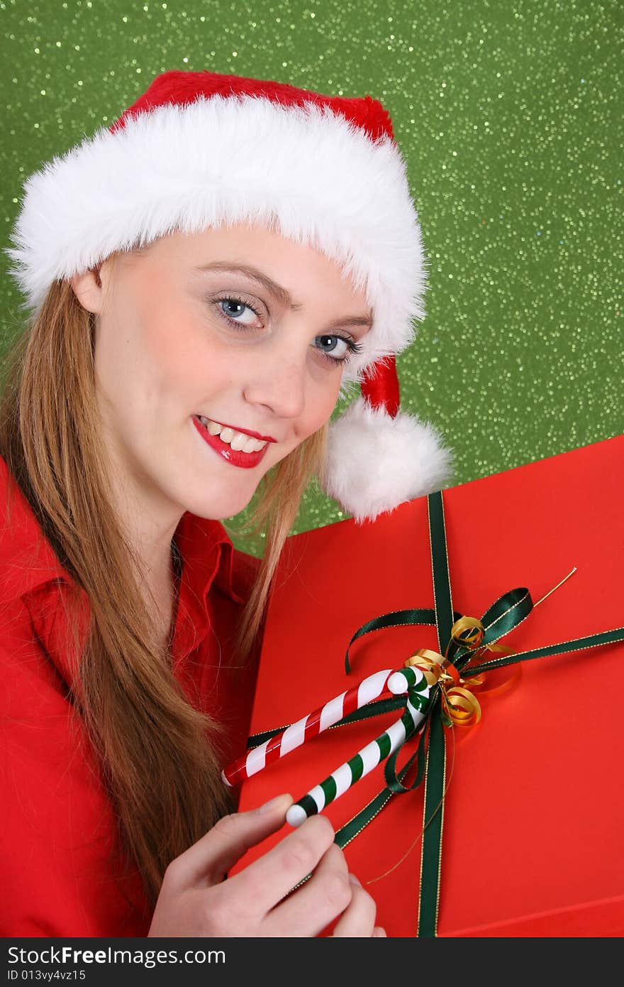 Christmas girl holding a red gift box with decorations. Christmas girl holding a red gift box with decorations