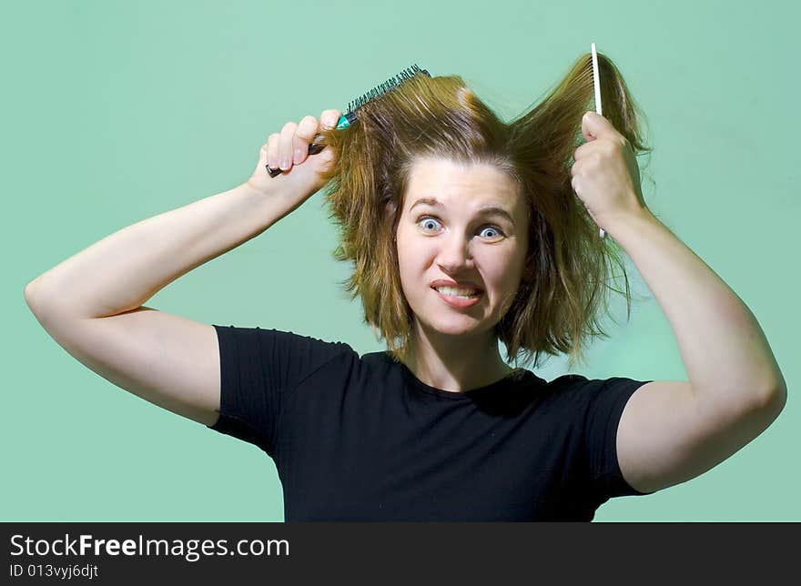 Young woman with combs. Humor's face.