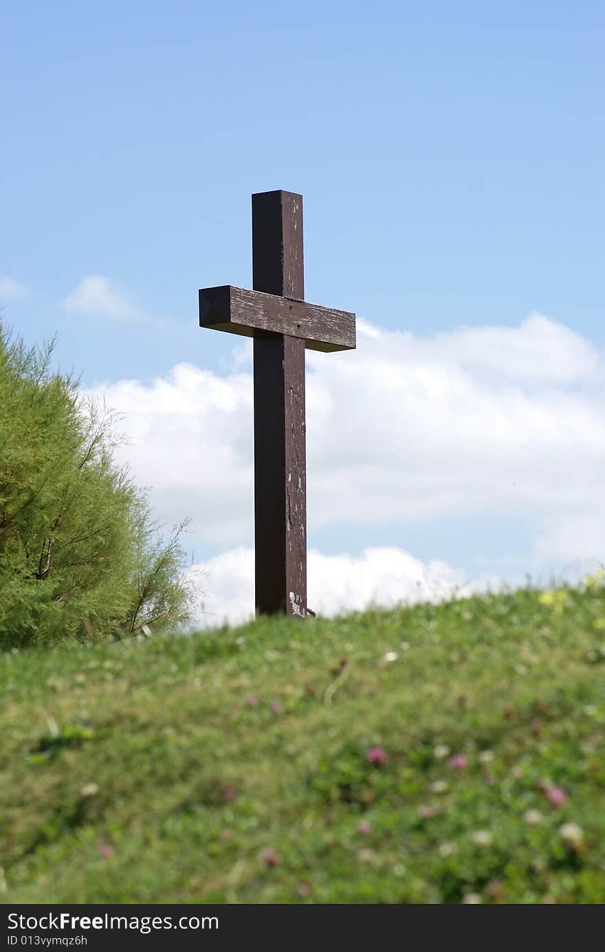 Wood cross at the top of the green hill. Wood cross at the top of the green hill