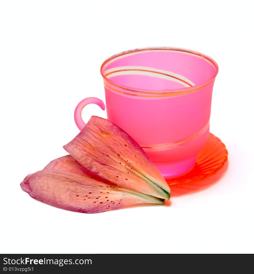 Cup and floral petal isolated on white