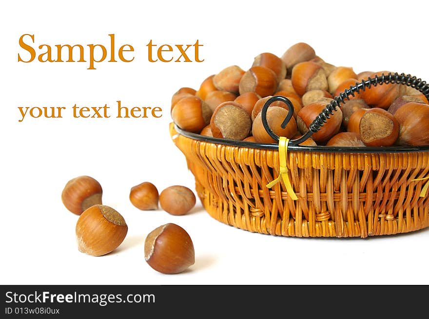 Wood nuts in a basket isolated on a white background. Wood nuts in a basket isolated on a white background