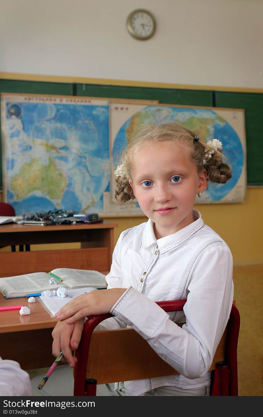 The beautiful girl with blue eyes at a geography lesson. The beautiful girl with blue eyes at a geography lesson.