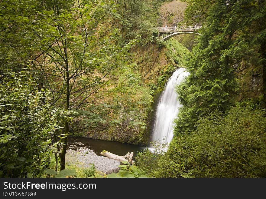 Peaceful waterfall and bridge