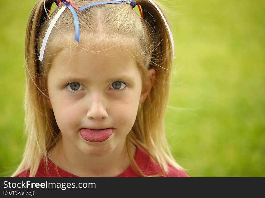 Little girl dressed in red making faces. Little girl dressed in red making faces