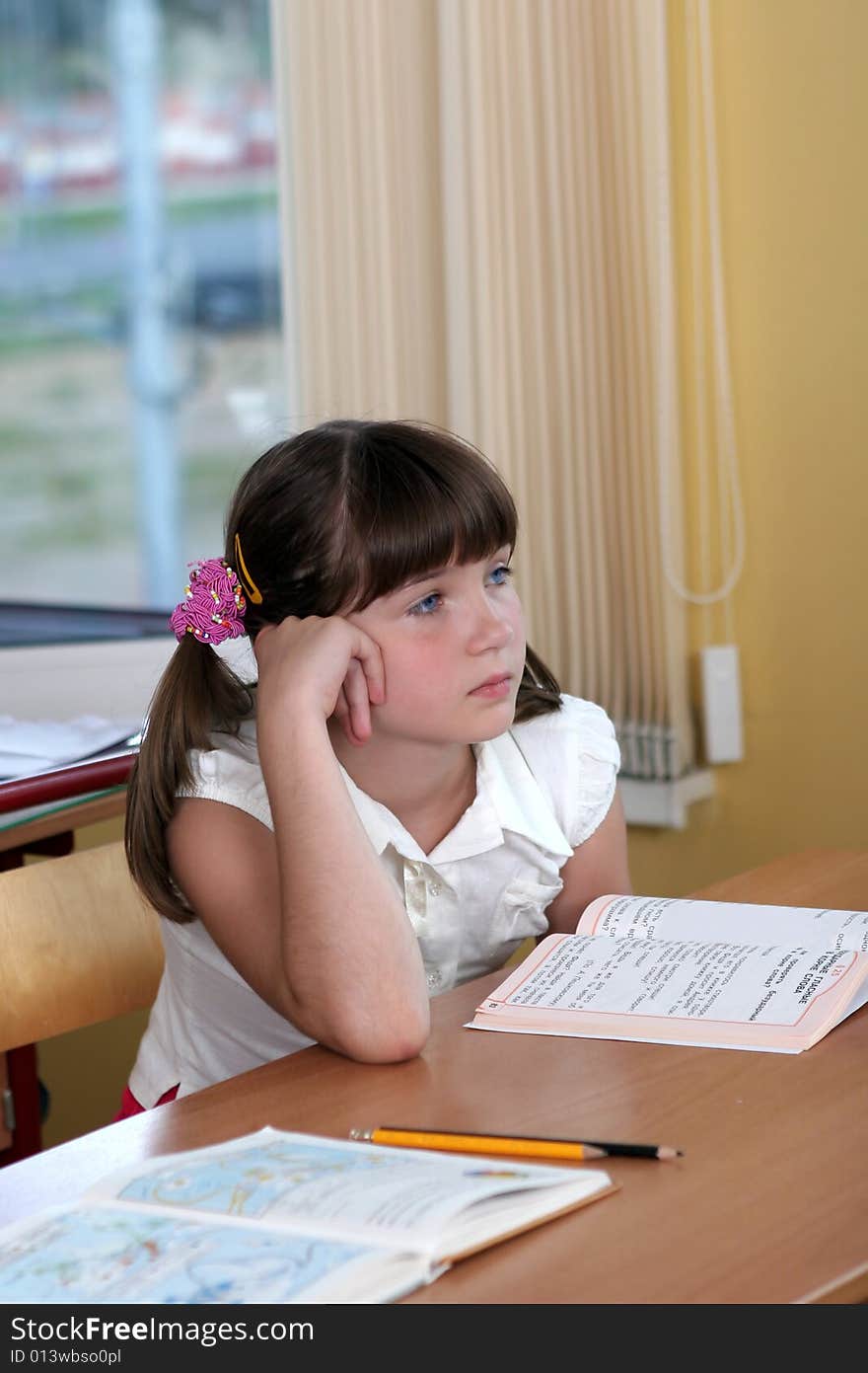 The beautiful girl with blue eyes at a  lesson. The beautiful girl with blue eyes at a  lesson.