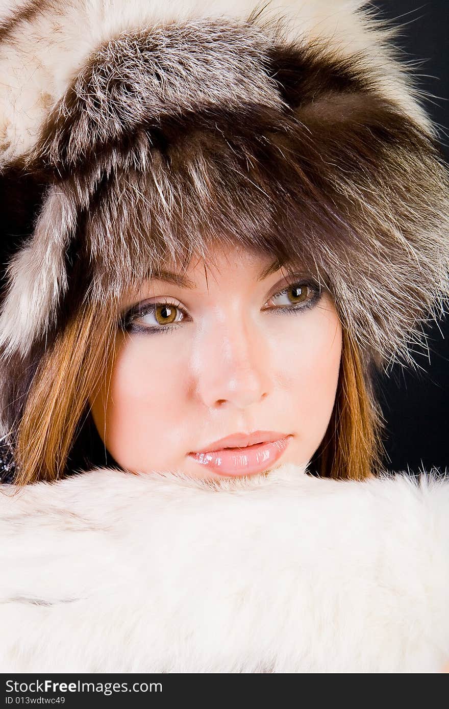 Close-up portrait of the girl in fur-cap