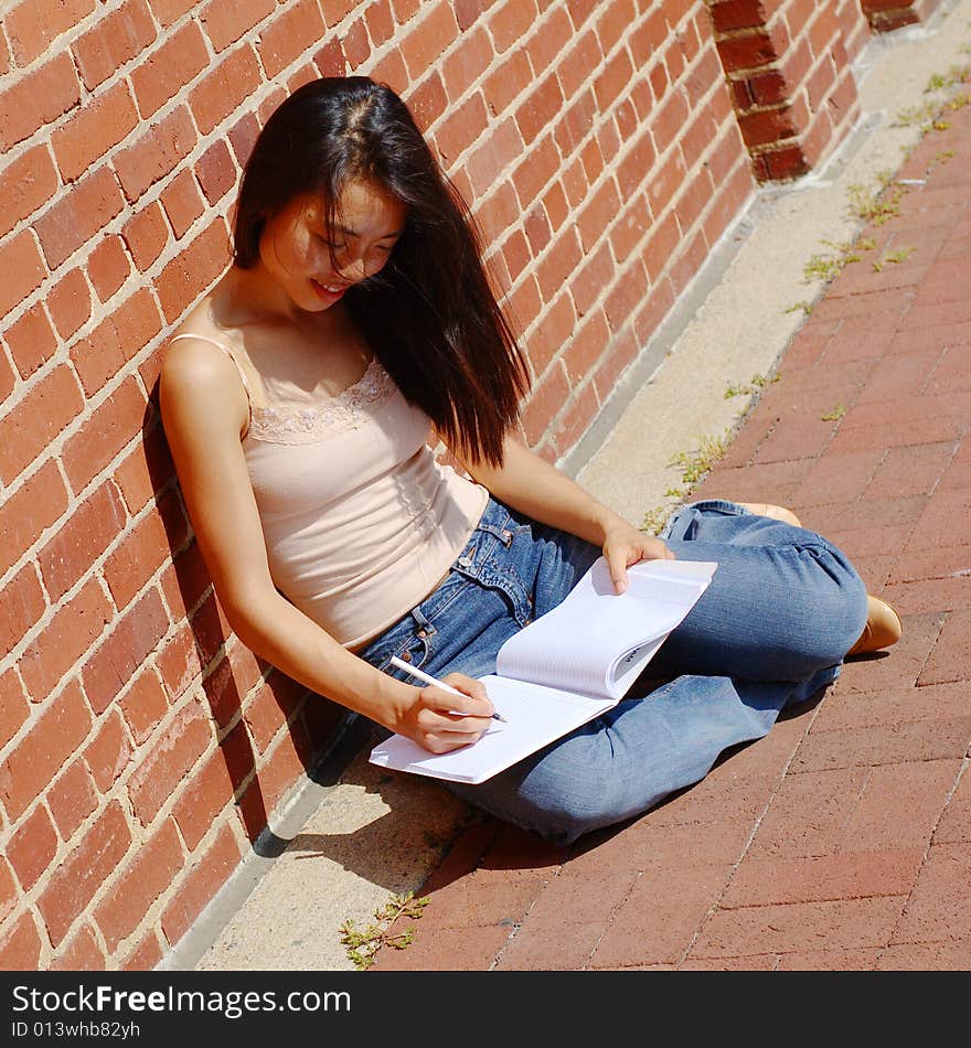 Girl Writing In Note Book