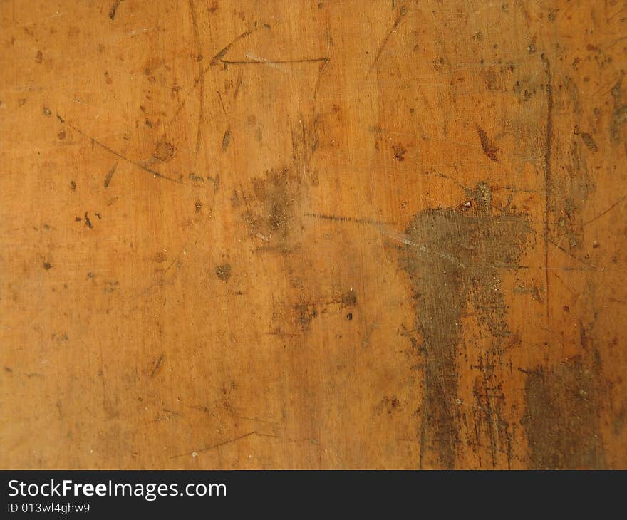 Scrapped and scratched light colored wooden surface. Scrapped and scratched light colored wooden surface