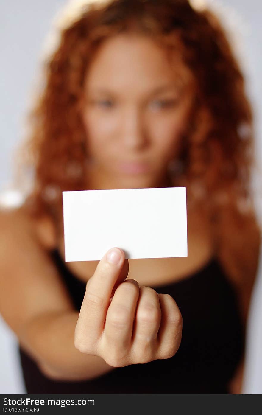 Pretty girl holding white blank media, against white. Pretty girl holding white blank media, against white.