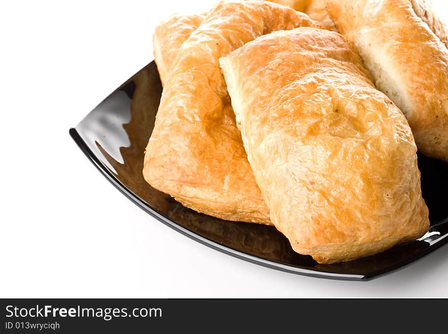 Fresh rolls on a plate on a white background