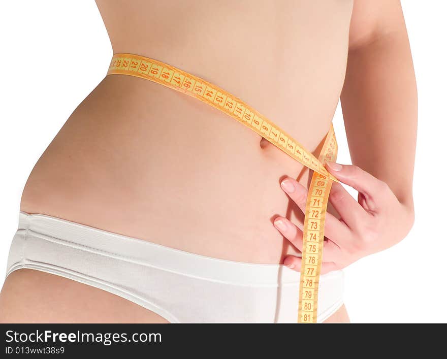 Woman measuring waist with a tape measure. Isolated