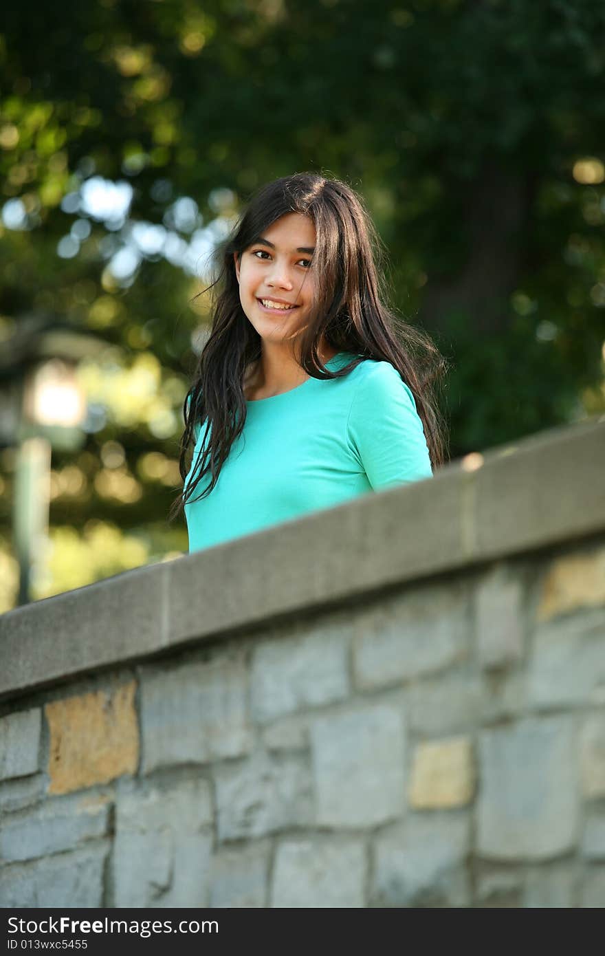 Young teen girl standing on bridge