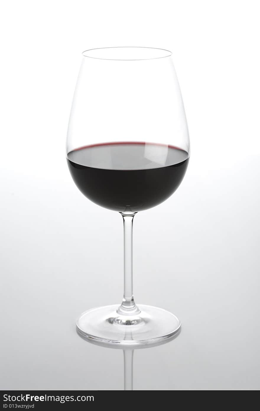 Glass of wine isolated on a light background. Glass of wine isolated on a light background