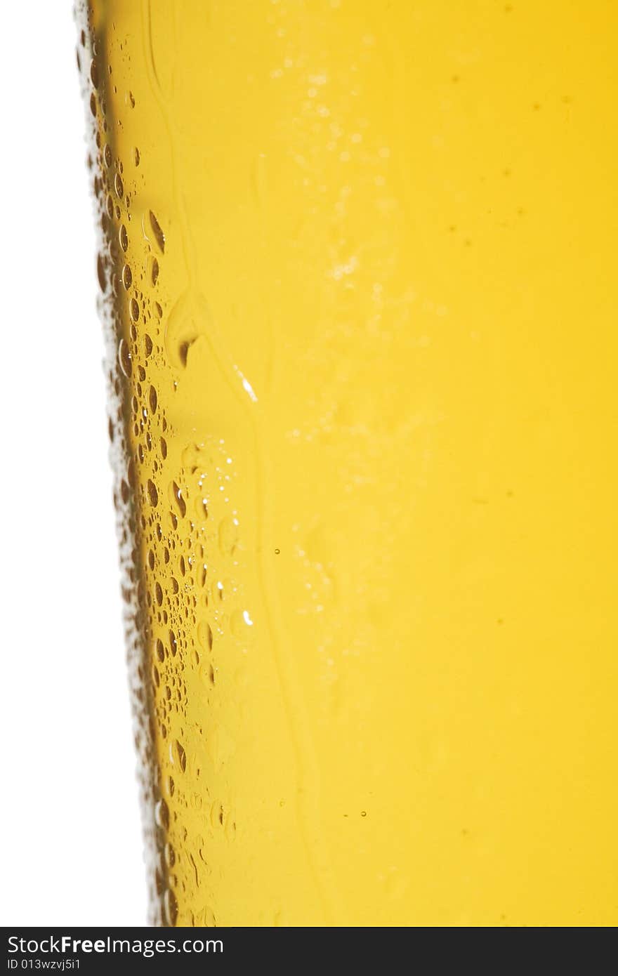 Closeup of condensation on a chilled light beer glass isolated on a white background