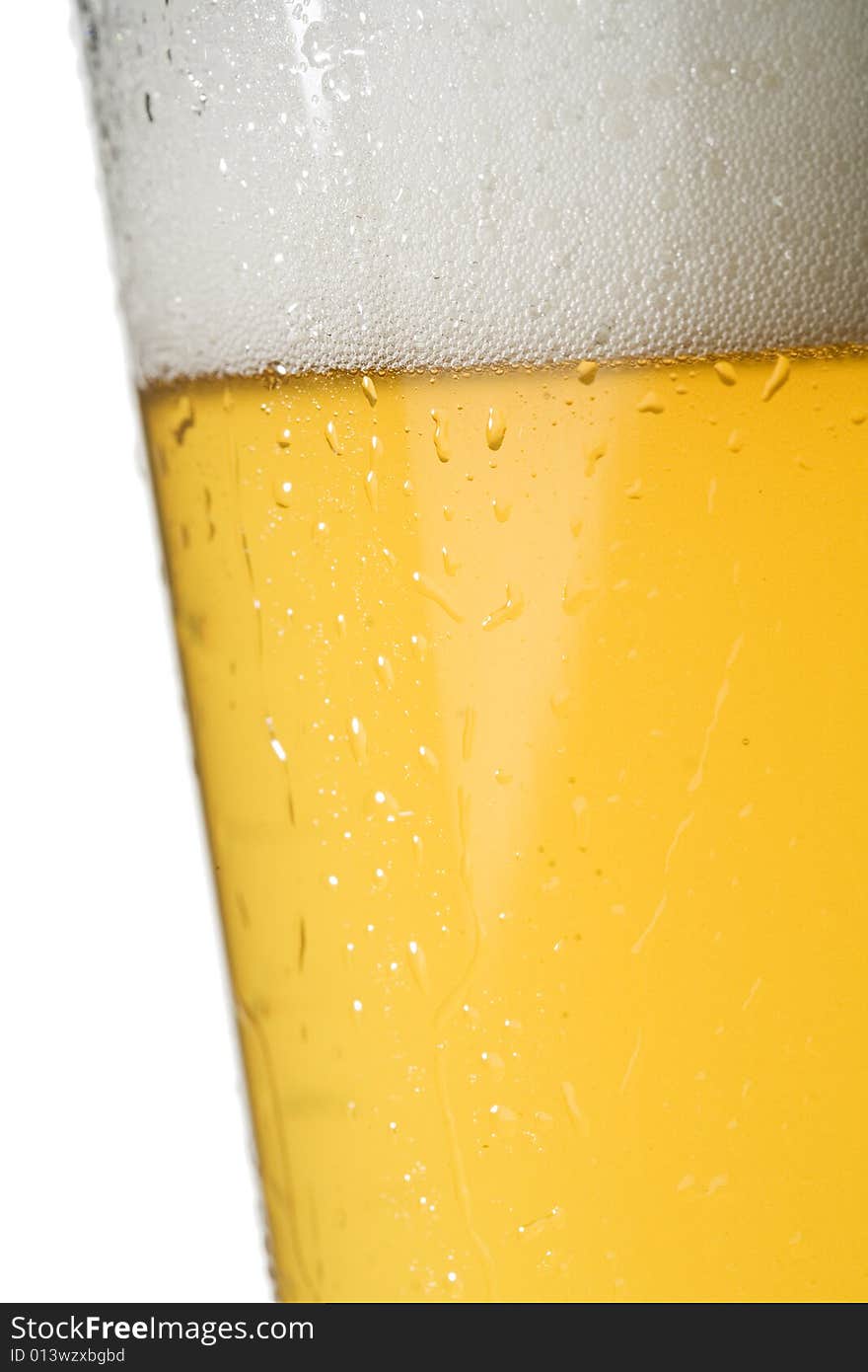 Closeup of condensation on a chilled light beer glass isolated on a white background