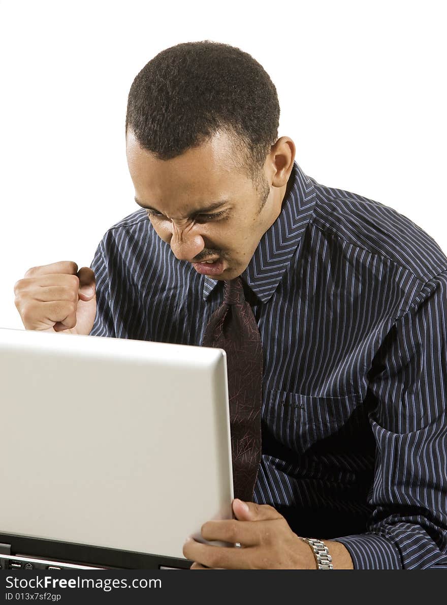 A young professional African-American male working on a laptop. A young professional African-American male working on a laptop.