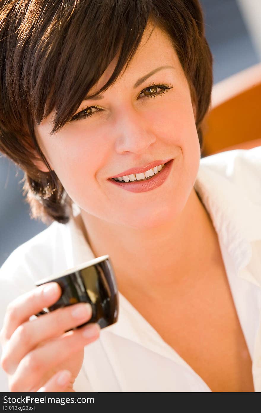 Lovely young girl with cup of coffee