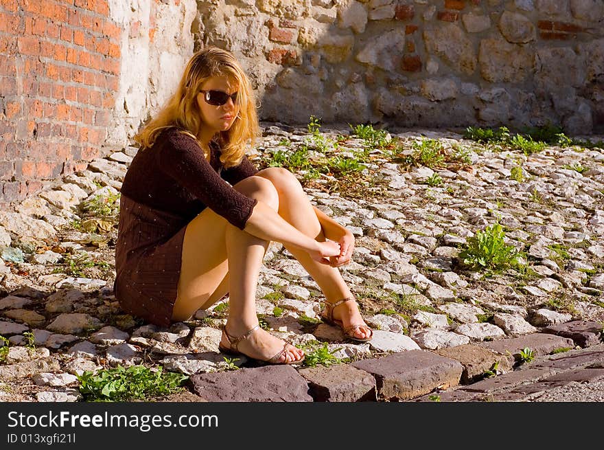 Thoughtful beauty woman sitting under the sunlight