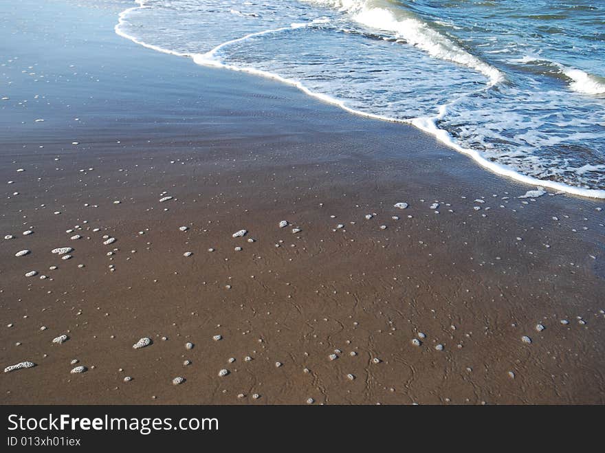 Close-up shot of Sand and Wave. Close-up shot of Sand and Wave