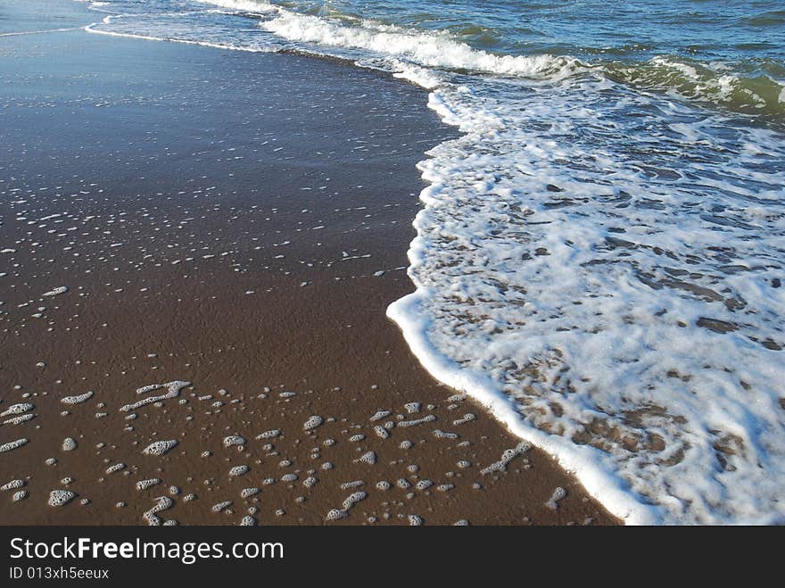 Close up shot of Wave and Sand. Close up shot of Wave and Sand