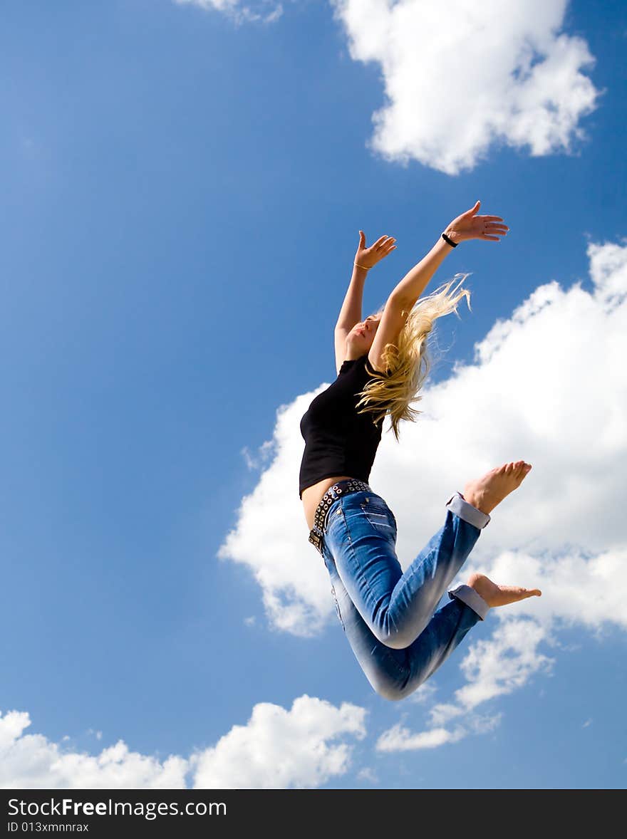 Pretty woman jumping on blue sky background. Pretty woman jumping on blue sky background