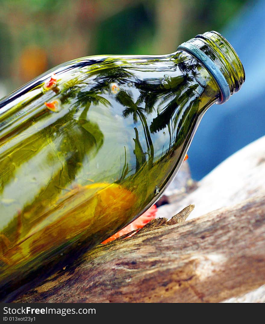 Beach scene reflected off green bottle. Beach scene reflected off green bottle