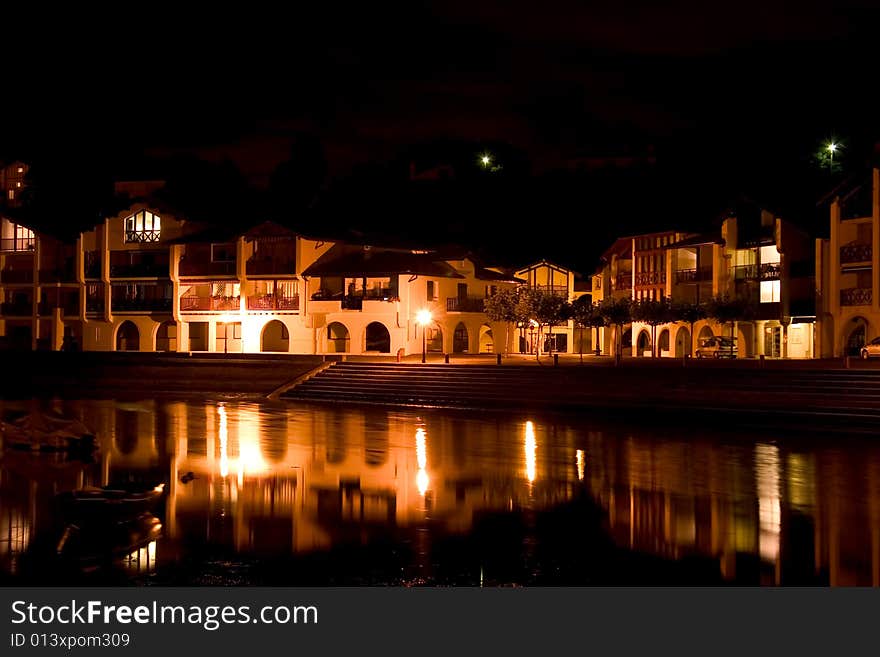 A village of white house at night near a river in the south of france. A village of white house at night near a river in the south of france