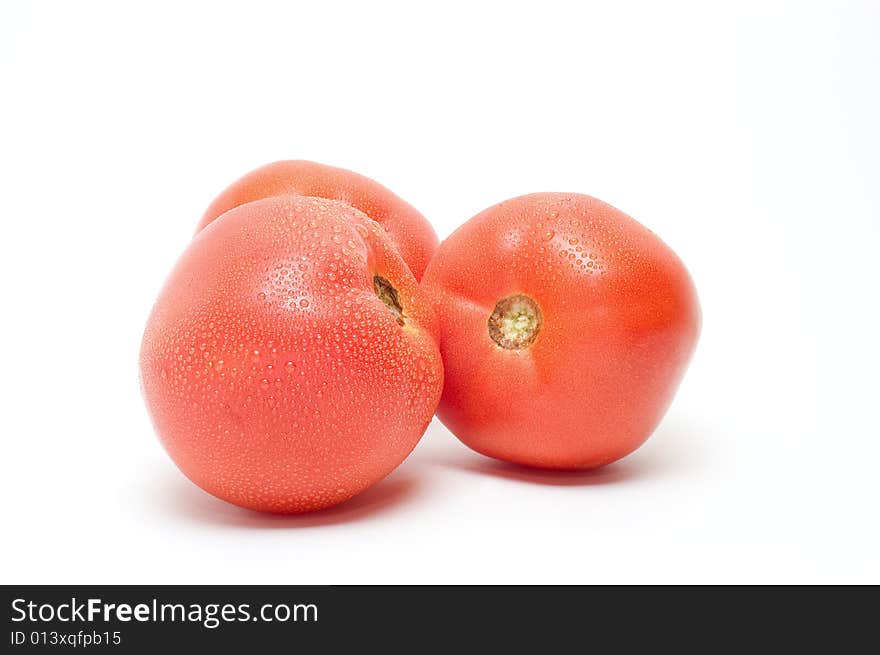 Three ripe tomatoes on white background