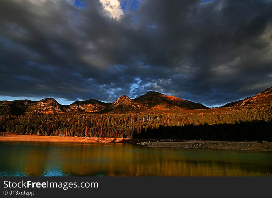 High mountain lake in the fall showing autumn colors reflected in the water