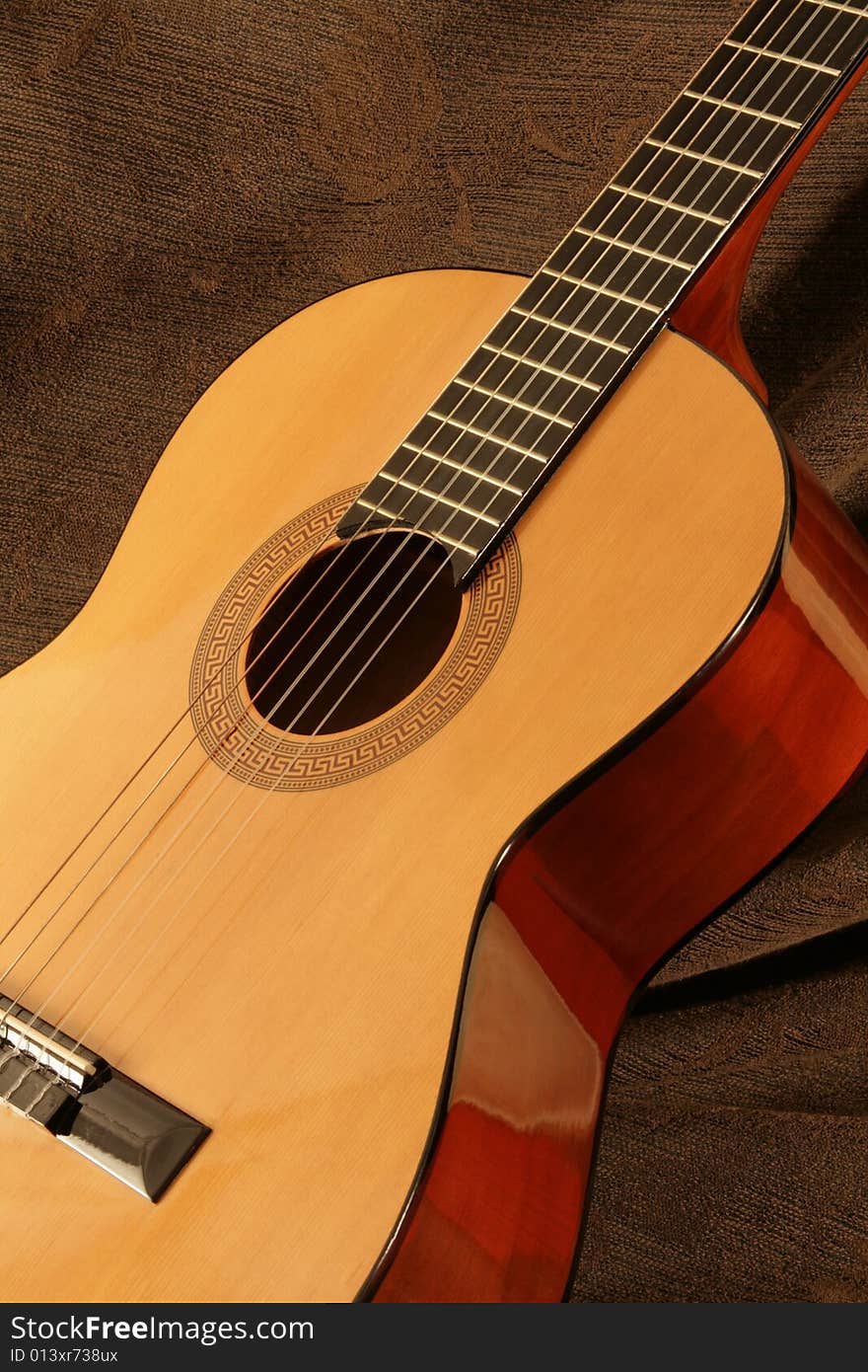 Classic guitar detail on brown background. Classic guitar detail on brown background