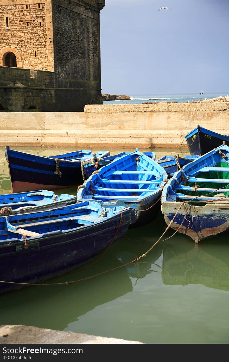 Blue fishing boats in Essaouira harbour Morocco