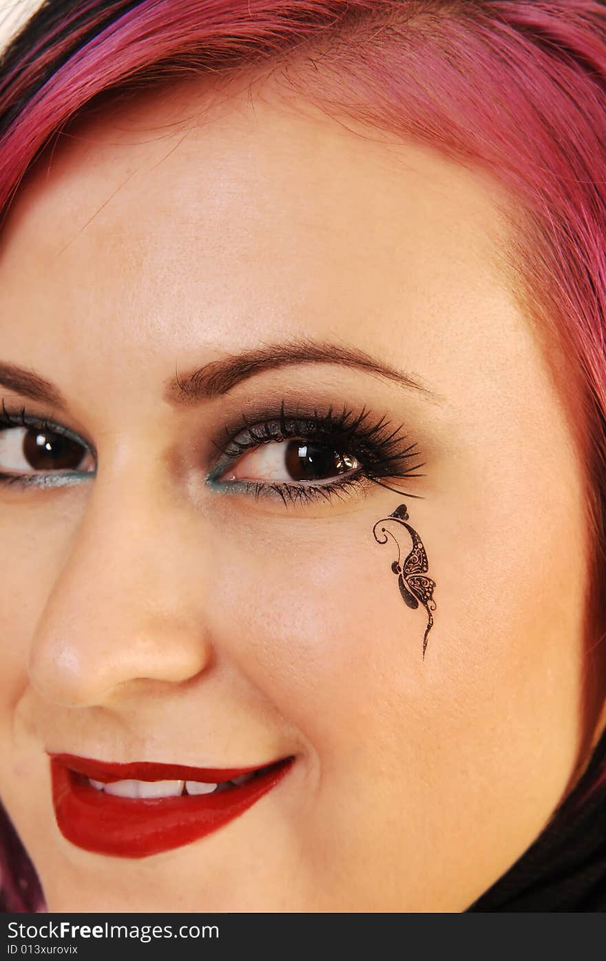 An close up head shot of a lovely, beautiful young woman with a
black butterfly on her cheek. An close up head shot of a lovely, beautiful young woman with a
black butterfly on her cheek.