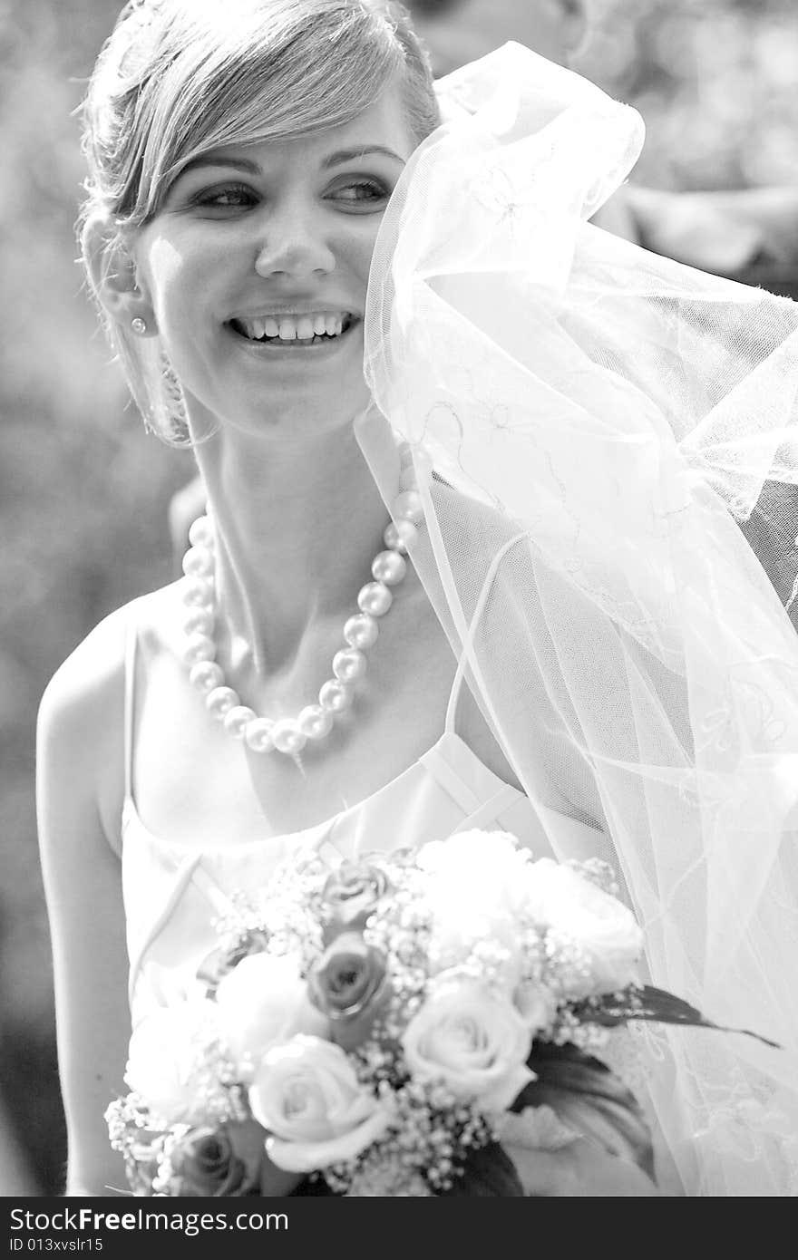 Young beautiful bride with flowers outdoor