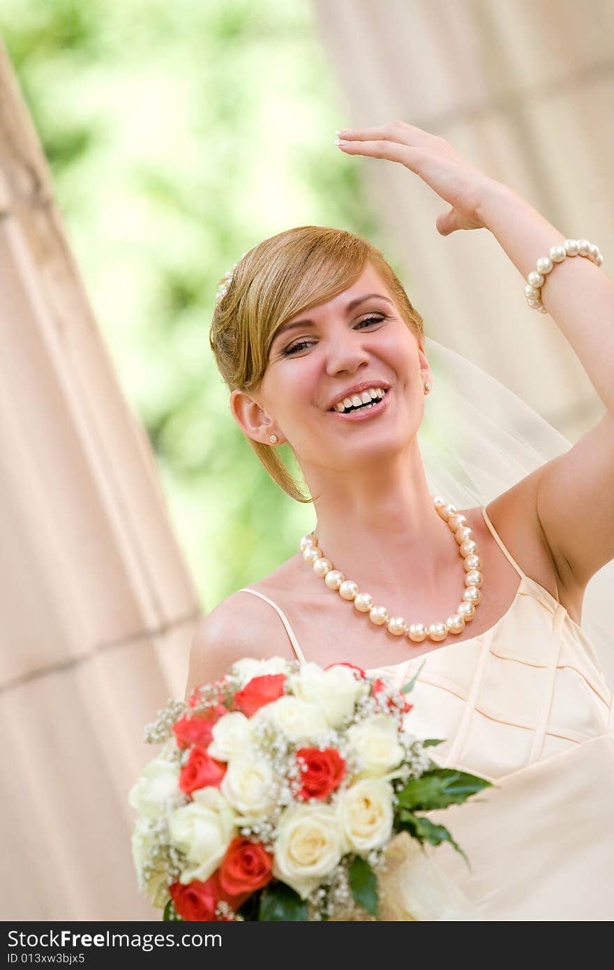 Young beautiful bride with flowers outdoor