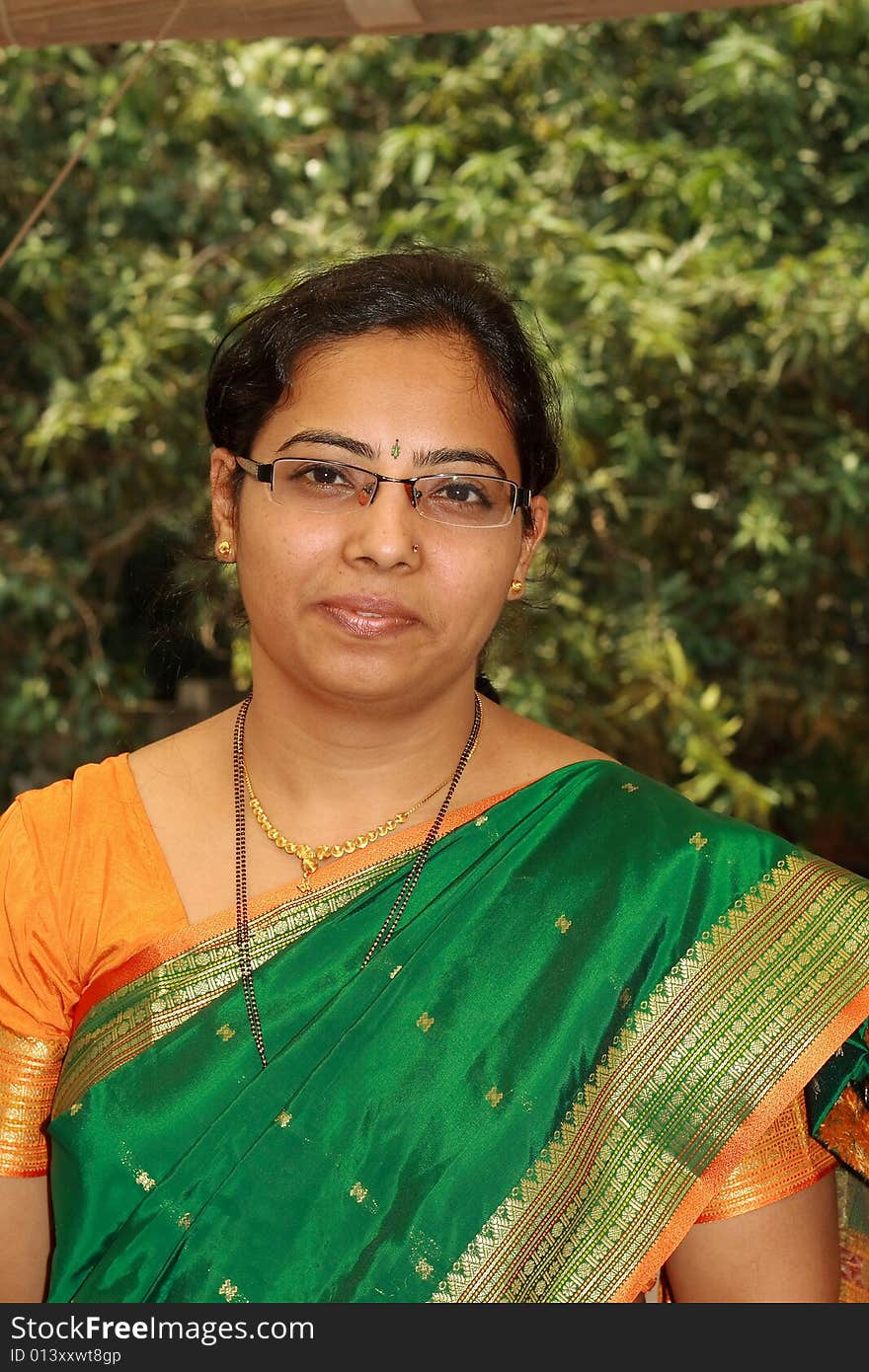 A simple Indian housewife in traditional clothes at the time of festival.