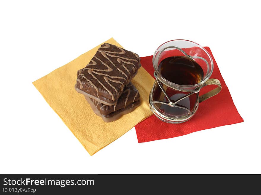 Cup of black tea and chocolate pastry on paper napkins. Cup of black tea and chocolate pastry on paper napkins