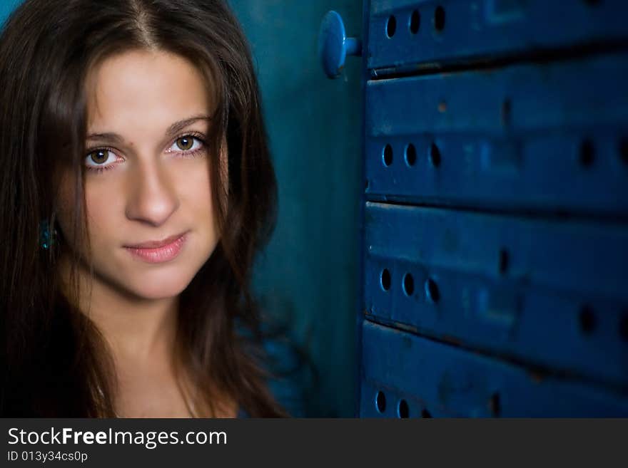 Nice girl is staing near mailbox and looking up with a smile. Nice girl is staing near mailbox and looking up with a smile