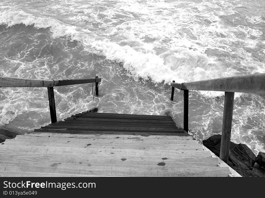 Black and white of stairs leading into the ocean. Black and white of stairs leading into the ocean