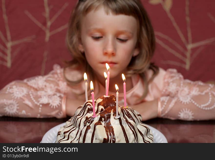 The girl celebrates birthday with cake at home