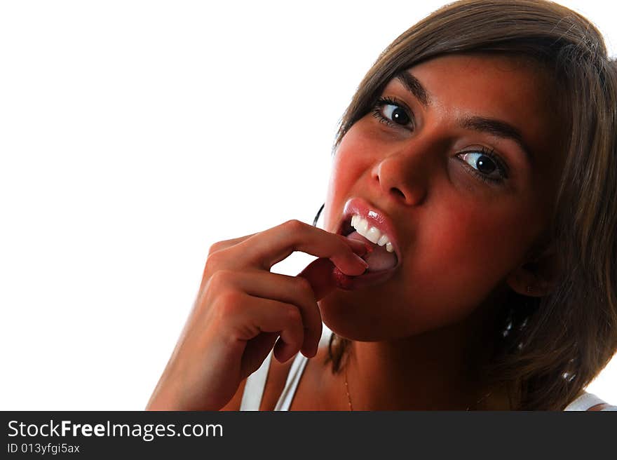 Attractive girl eating raspberry over white background