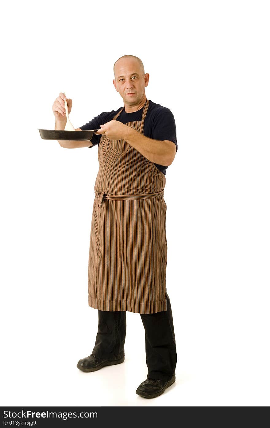 Man in his 40's with an apron and cooking utensils isolated on white. Man in his 40's with an apron and cooking utensils isolated on white