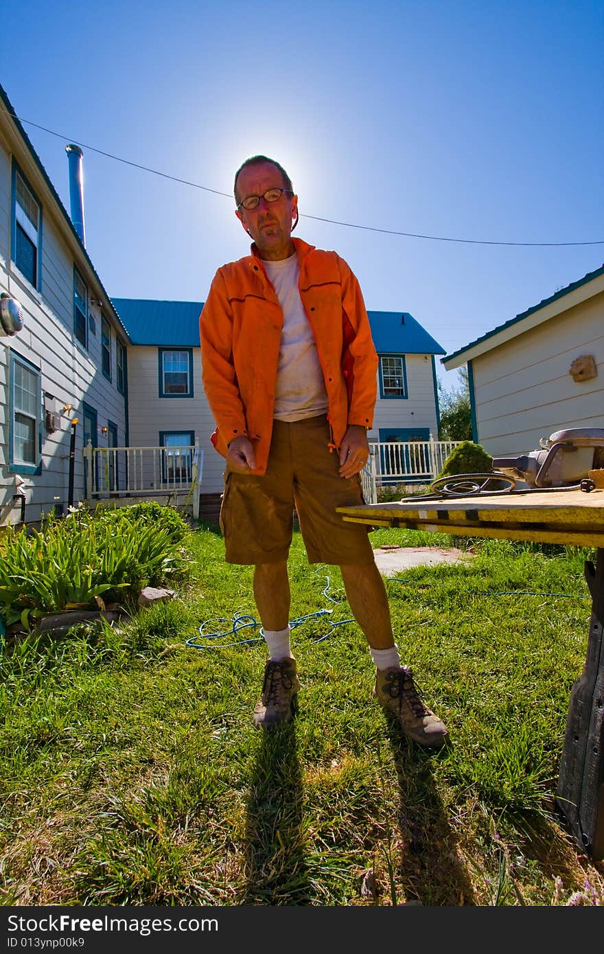 Portrait of older construction worker against blue sky