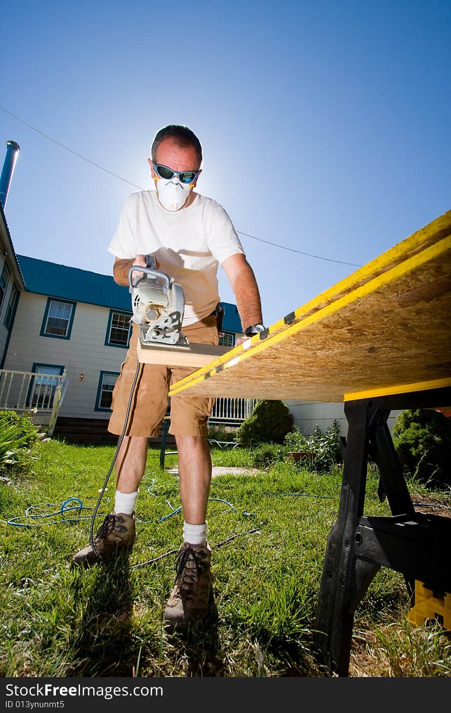 Portrait of older construction worker against blue sky