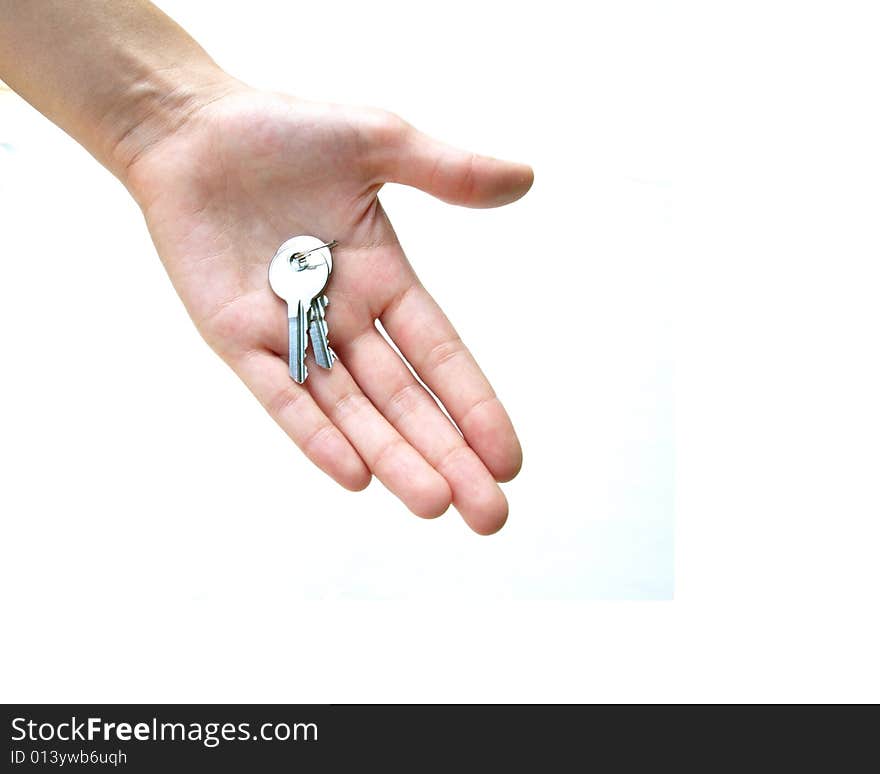 Close up of palm of hand holding two small silver keys, against white background. Close up of palm of hand holding two small silver keys, against white background.