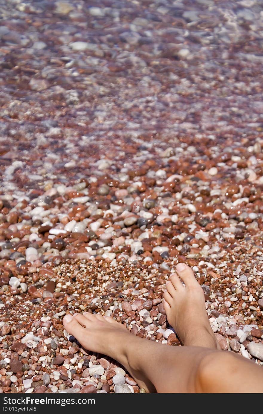 Gravel beach with relaxed legs