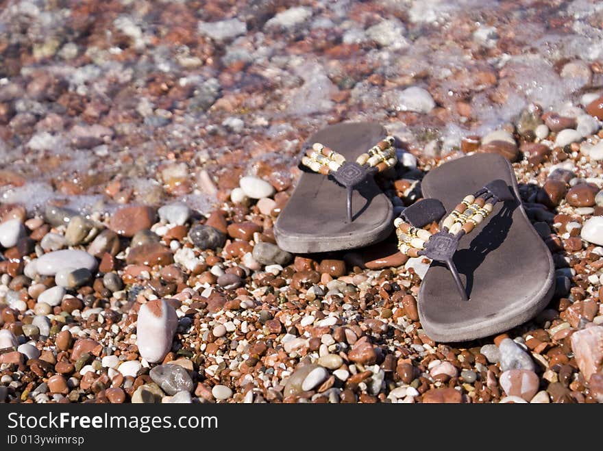 Gravel beach with flip-flops