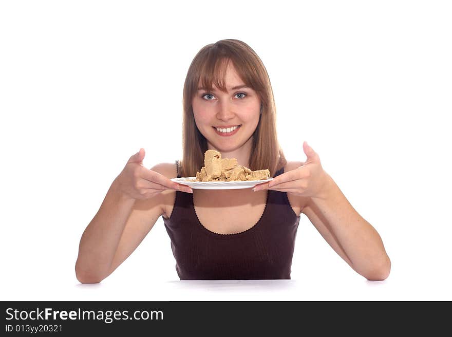 The girl holds a plate with halvah